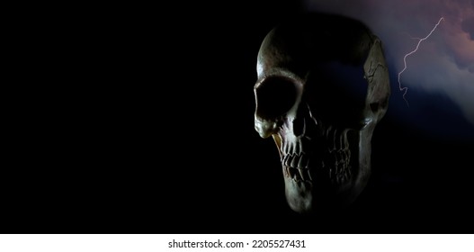 Human Skull With Rim Lighting And Lghtning Behind