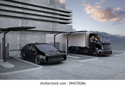 Hybrid Electric Truck And White Electric Car In Charging Station