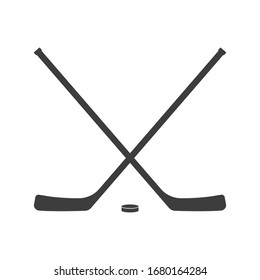 Ice hockey crossed sticks and puck icon Black silhouette isolated on white background. Sport equipment symbol. 
