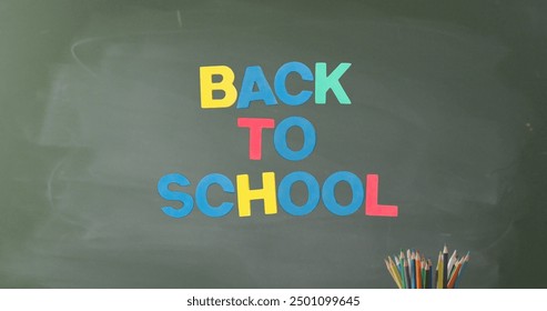 Image of back to school text over pencils on grey background. Education, learning and school concept digitally generated image. - Powered by Shutterstock