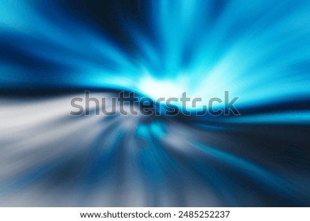 Image of a blue light trail distorting and spreading at the speed of light through a dark space.
