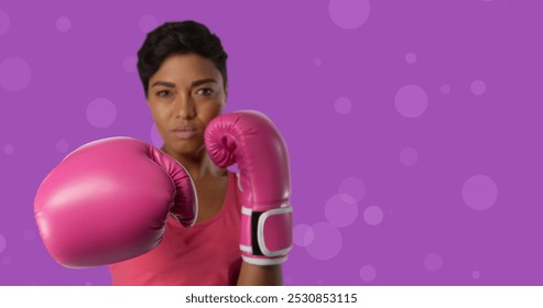 Image of breast cancer awareness text over biracial female boxer. breast cancer positive awareness campaign concept digitally generated image. - Powered by Shutterstock