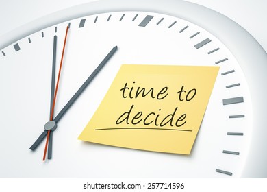 An image of a bright clock with a sticky note and the message time to decide
