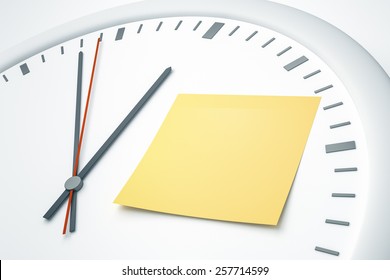 An image of a bright clock with a sticky note