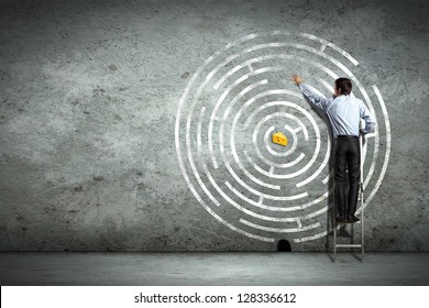 Image of businessman standing on ladder against maze picture - Powered by Shutterstock