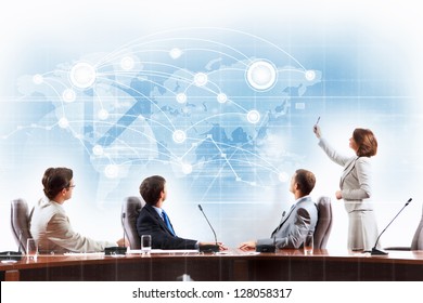 Image of businesspeople at presentation looking at virtual project - Powered by Shutterstock