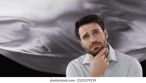 Image of caucasian man thinking over floating cloth on black background. Thoughts, abstraction and lifestyle, digitally generated image. - Powered by Shutterstock