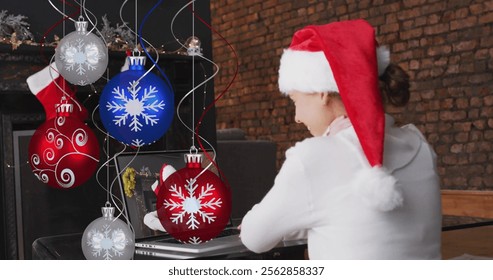 Image of christmas decorations over happy caucasian woman in santa hat on laptop image call. christmas, tradition and celebration concept digitally generated image. - Powered by Shutterstock