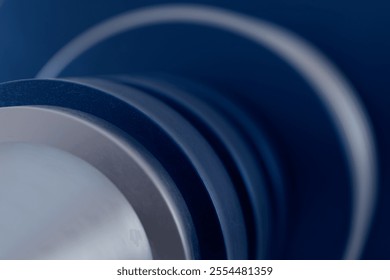 The image is a close up of a blue object with a silver rim. The blue color is bold and striking, while the silver rim adds a touch of contrast and sophistication. Scene is one of elegance