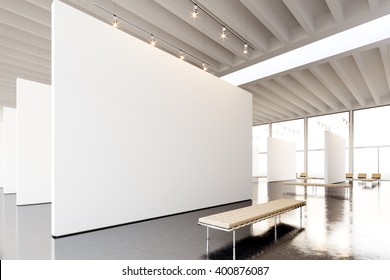 Image Exposition Modern Gallery,open Space.Blank White Empty Canvas Hanging Contemporary Art Museum.Interior Loft Style Concrete Floor,light Spots,generic Design Furniture And Building. 3d Rendering