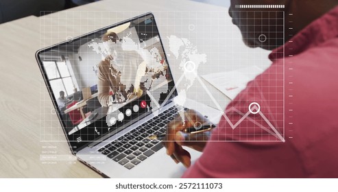 Image of financial data processing over african american man on laptop video call. Global finance, business, connections, computing and data processing concept digitally generated image.