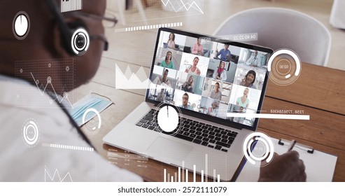 Image of financial data processing over african american man on laptop video call. Global finance, business, connections, computing and data processing concept digitally generated image.