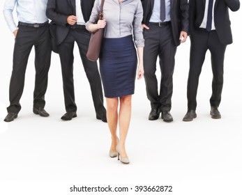 Image Of A Group Of Young Businessmen Standing With A Businesswoman Walking In Front. Leading The Way, Diversity Or Harassment Concept. Photo Realistic 3d Model Scene.