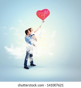 Image Of Happy Father Holding His Daughter And A Red Heart Baloon