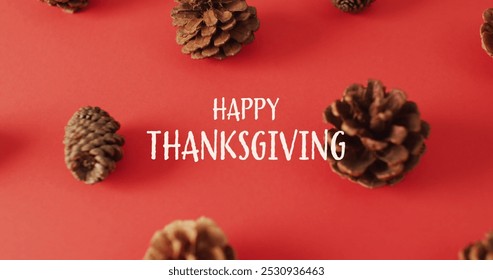 Image of happy thanksgiving text and pine cones on red background. Thanksgiving, american tradition and celebration concept digitally generated image. - Powered by Shutterstock