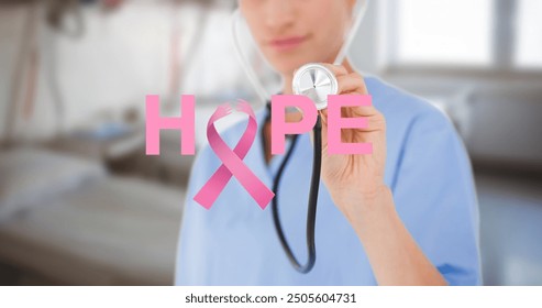 Image of hope and breast cancer awareness ribbon and caucasian female doctor with stethoscope. breast cancer awareness and healthcare concept digitally generated image. - Powered by Shutterstock