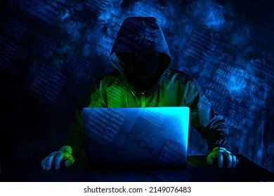 Image Of A Man In A Black Hoodie Pointing To The Screen Of A Laptop Computer At Home And Remotely Controlling It, Under A Blue-green Glowing Binary Data In A Glass Cube On Chains.