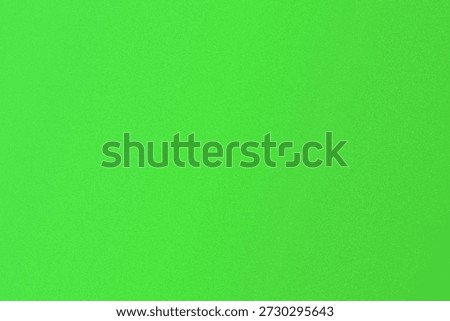 The image shows a solid green background with a subtle texture. The color is vibrant and uniform, giving a sense of simplicity and calmness.