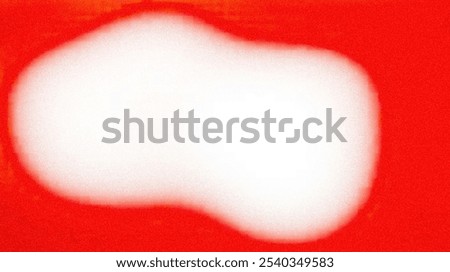 The image shows a white, blurred shape against a red background. The shape is vaguely circular and has a soft, fuzzy edge.