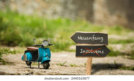 An image with a signpost pointing in two different directions in German. One direction points to a fresh start, the other points to bankruptcy.