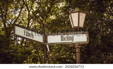 An image with a signpost pointing in two different directions in German. One direction points right, the other points wrong.