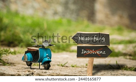An image with a signpost pointing in two different directions in German. One direction points to a fresh start, the other points to bankruptcy.