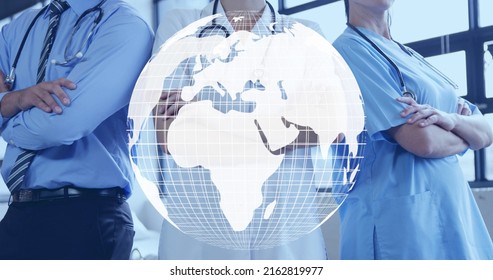 Image Of Spinning Globe Model Over Diverse Medical Staff. World Health Day Concept Digitally Generated Image.