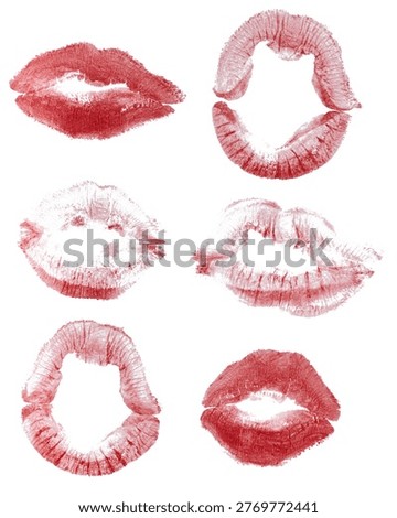 Imprints of human lips painted with red lipstick on a white background