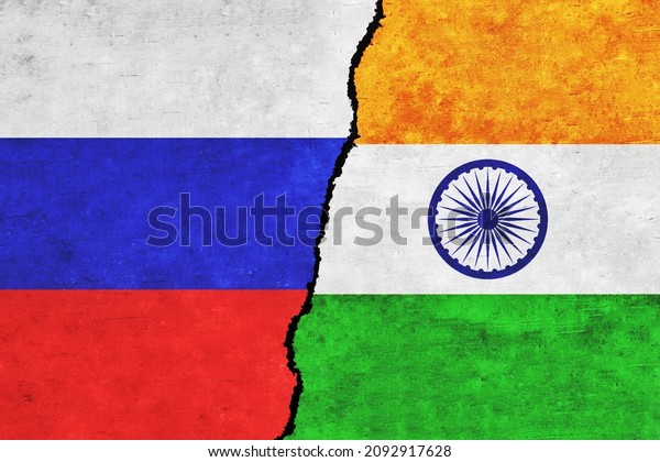 India and Russia painted flags on a wall with a\
crack. India and Russia conflict. Russia and India flags together.\
India vs Russia