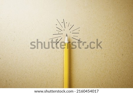 Individuality, creative idea and uniqueness concept with yellow pencil veiled under a burning light bulb on kraft paper background. 3D rendering
