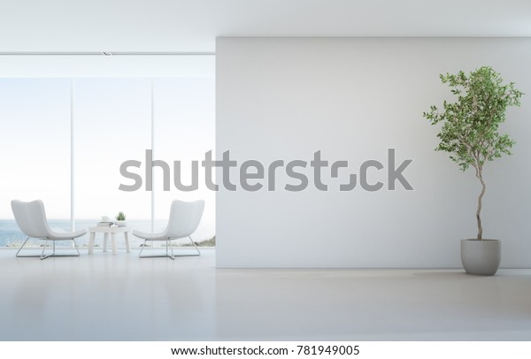 Indoor plant on white floor with empty\
concrete wall background, Lounge and coffee table near glass window\
in sea view living room of modern luxury beach house or hotel -\
Home interior 3d\
illustration