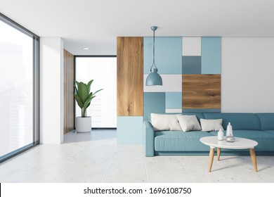 Interior Of Bright Panoramic Living Room With White And Colorful Pattern Wall, Tiled Floor, Comfortable Blue Sofa And Round Coffee Table. Window With Blurry Cityscape. 3d Rendering