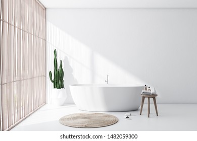 Interior of comfortable bathroom with white walls and floor, light wooden blinds, comfortable white bathtub with round carpet and chair with towels. 3d rendering