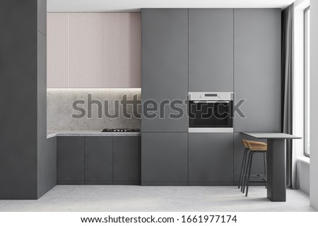 Interior of compact kitchen with white and stone walls, concrete floor, grey countertops and cupboards with built in oven and table with bar stools. 3d rendering Foto d'archivio © 