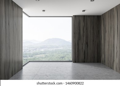 Interior of empty room with dark wooden walls, concrete floor, stylish ceiling lamps and large window with mountain view. 3d rendering