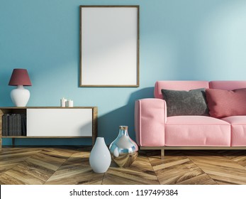 Interior of living room with light blue walls, wooden floor with vases on it, a cabinet with books, candles and lamp and vertical mock up poster frame. Pink sofa. 3d rendering