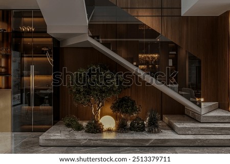 Interior of the modern duplex house features a staircase, plants, and a light fixture