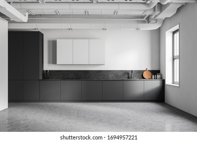 Interior Of Modern Industrial Style Kitchen With White And Grey Walls, Concrete Floor, Grey Countertops With Built In Appliances And White Cupboards. 3d Rendering