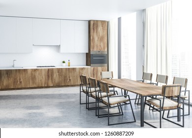 Interior Of Modern Kitchen With White Walls, Stone Floor, White Cupboards And Wooden Countertops And Long Wooden Table With Chairs. 3d Rendering