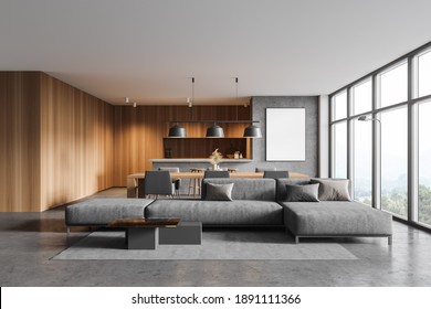 Interior of modern living room with gray and wooden walls, concrete floor, gray sofa and kitchen in the background. Vertical mock up poster. 3d rendering