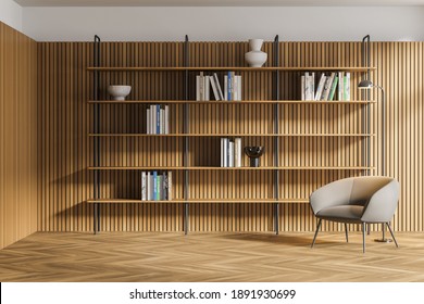 Interior Of Modern Living Room Or Home Library With White And Wooden Walls, Wooden Floor, Comfortable Armchair And Bookcase. 3d Rendering