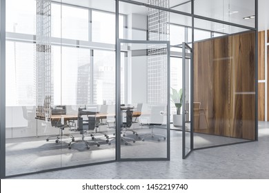 Interior Of Modern Meeting Room With White, Glass And Wooden Walls, Concrete Floor, Long Wooden Table And Black Armchairs. Office Hall. 3d Rendering