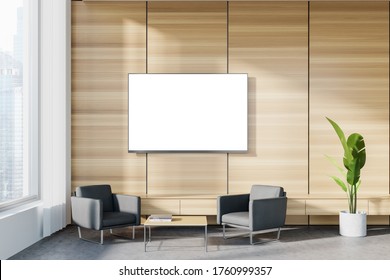 Interior Of Panoramic Corporate Office Waiting Room With White And Wooden Walls, Concrete Floor, Two Comfortable Gray Armchairs And TV With Mock Up Screen. Blurry Cityscape. 3d Rendering