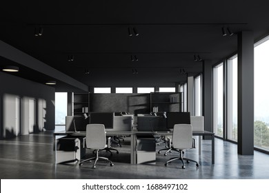 Interior Of Panoramic Open Space Office With Dark Grey Walls, Concrete Floor And Rows Of Gray Computer Tables. Consulting Company Concept. Windows With Blurry Mountain View. 3d Rendering