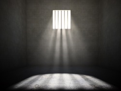 Interior Of A Prison Cell With Light Shining Through A Barred Window