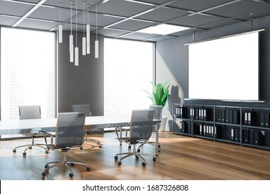 Interior Of Stylish Meeting Room With Gray Walls, Wooden Floor, Long Conference Table With Black Chairs And Mock Up Projection Screen. Concept Of Corporate Style. Blurry Cityscape. 3d Rendering