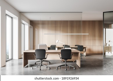 Interior Of Stylish Office With White And Wooden Walls, Concrete Floor, Computer Table And Meeting Room In The Background. 3d Rendering