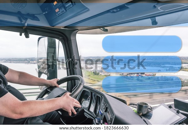 Interior of a truck cab with a driver while\
driving. Blank rectangles are ready for your use as template,\
information or\
presentation.