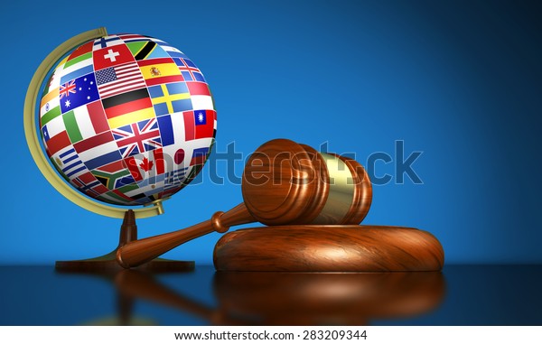 International law systems, justice,\
human rights and global business education concept with world flags\
on a school globe and a gavel on a desk on blue\
background.