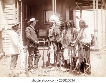 The Interview. Three Cheyenne men, Standing Elk, No. 1; Running Hog, No. 2; Little Wolf, No. 3, with Col. Oelrich, No. 4; Interpreter, No. 5. Dakota Territory. photo by John C. Grabill, 1887
